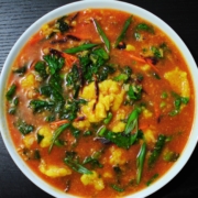 Tomato, artichoke drop soup with rice, kale, and carrots.