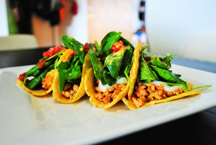 Tacos with spicy tempeh, white miso sauce and baby greens Tacos with spicy tempeh, white miso sauce and baby greens