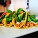 Tacos with spicy tempeh, white miso sauce and baby greens