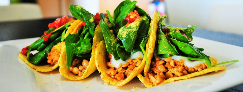 Tacos with spicy tempeh, white miso sauce and baby greens