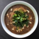 Black lentil and amaranth soup with sesame and roasted kale